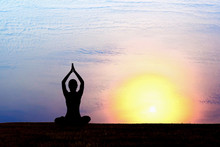 Silhouette Of Woman Practicing Yoga At Sunrise