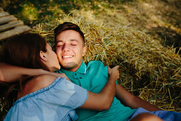 Wall Mural - man and woman lie on hay