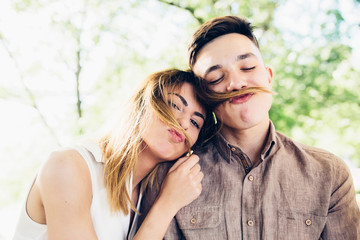 Wall Mural - guy doing mustache of girl's hair