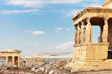 Ancient Greek Acropolis. The famous Porch of the Caryatids with six statues supporting the architrave, the southern part of the temple of the Erechtheion and fragment of the Propylaea