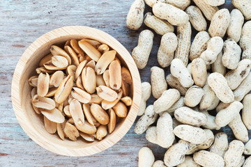 Wall Mural - Roasted salted peanuts in wooden bowl.

