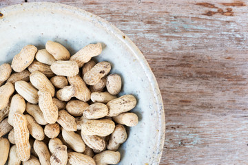 Poster - dried peanuts in ceramic bowl
