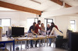 © Monkey Business - Wide Angle Shot Of Designers Brainstorming In Office Meeting