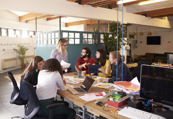 Wide Angle Shot Of Female Manager At Brainstorming Meeting