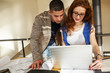 © BalanceFormCreative - Two office workers working on new project .They discuss and looking in laptop.