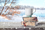 Fototapeta Sport - Pile of books, glasses and cup outdoors in winter
