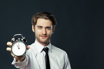 Alarm clock on businessman's hand