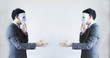 © twinsterphoto - Two men in business suit handshaking with masks on - Business fraud and hypocrite agreement
