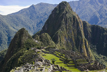 The Ancient Inca Ruins Of Machu Picchu Nestled Among The Green Mountain Peaks In Peru, South America.  Machu Picchu Was Recently Voted As One Of The Seven Wonders Of The World.