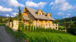 Traditional wooden mountain house built from wood logs on summer sunny day