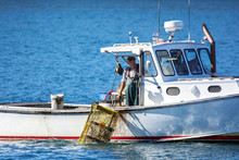 Lobster Fishing Boat In Autumn Against Deep Blue Ocean Water In Coastal Maine, New England