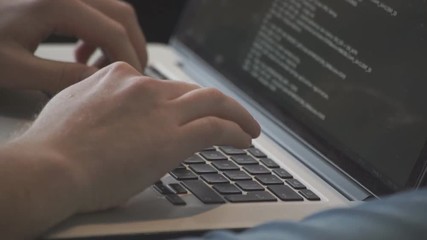 Programmer occupation - writing programming code on laptop