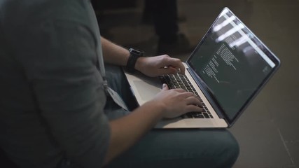 programmer occupation - writing programming code on laptop