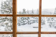 © Baikal360 - snowy forest trees in the snow outside the window with a wooden