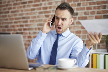 Angry man talking on the phone.