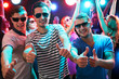 © chagin - Group of guys dancing in the night club