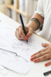 © Westend61 - Landscape architect drawing at desk, close-up