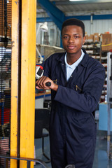 Wall Mural - Factory Worker Using Powered Fork Lift To Load Goods