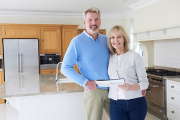 Wall Mural - Mature Couple Looking Around Kitchen Of House For Sale