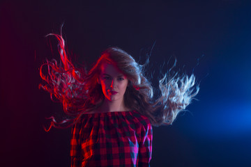 Wall Mural - Woman with long curly hair in motion at studio