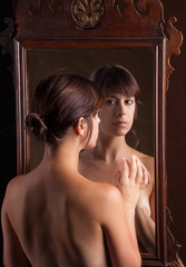 Wall Mural - Topless Woman Looking at Reflection in Mirror