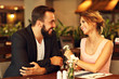 © Kalim - Romantic couple dating in restaurant