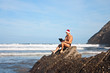 © katrin888 - Man in christmas hat using laptop on the beach