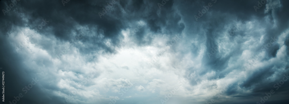 Dramatic Sky Background. Stormy Clouds in Dark Sky. Moody Cloudscape. Panoramic Image Can Be Used as Web Banner or Wide Site Header. Toned and Filtered Photo with Copy Space. - obrazy, fototapety, plakaty 