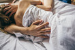 beautiful couple lying together on the bed. male hand closeup