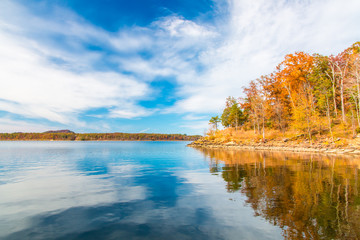 Wall Mural - Autumn season at lake with beautiful forest at hill shore.