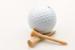 Golf ball and tees on a white background.