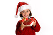 © javiindy - Little girl wearing santa hat carrying many gift boxes