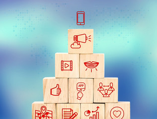 Poster - Mobile marketing feature icon on wood cube pyramid with blur blu