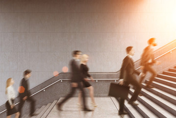 Wall Mural - Side view of entrepreneurs climbing a stair in a building, toned