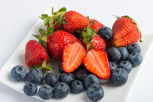 Fresh Strawberries And Blueberries On White Background