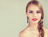 Beautiful young woman  with braid and red lips . Fashion jewelry ,beauty  earrings
