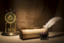 Literature Concept. Old Inkstand With Feather Near Scroll And Vintage Clock On Canvas Background