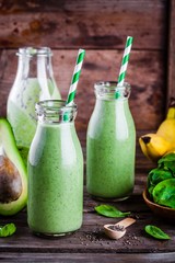 Wall Mural - healthy green smoothie with banana, spinach, avocado  and chia seeds in glass bottles