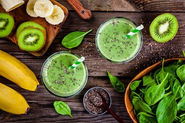 Wall Mural - healthy green smoothie with banana, kiwi, spinach and chia seeds in glass jars