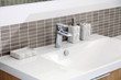 White sink and dispenser in bathroom