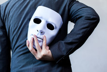 Business Man Carrying White Mask To His Body Indicating Business Fraud And Faking Business Partnership