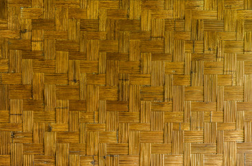 twill weave wickerwork of old thai house wall. the natural wicker is a rigid material made of bamboo