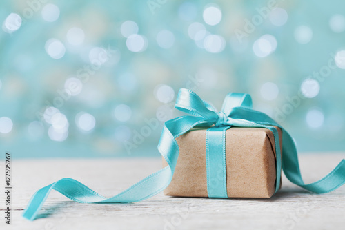Fotografía Christmas gift box against turquoise bokeh background