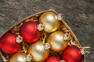 Christmas balls red and gold in a wooden basket top view of vint