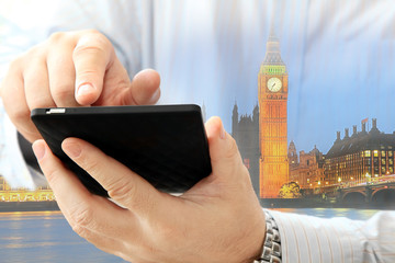 Poster - Close up of man using smartphone on London Big Ben background 