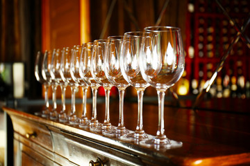 Poster - Row of empty wine glasses on bar counter