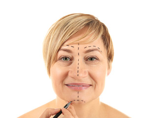 Poster - Surgeon hand drawing marks on female face for plastic operation