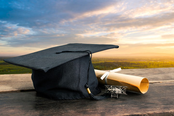 graduation cap, hat with degree paper on wood table Empty ready