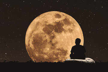 silhouette a man sitting relaxing under full moon at night with stars on the sky