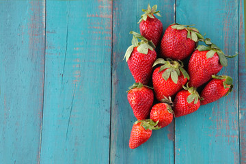 Group of fresh red strawberries in a shape of one big red strawb